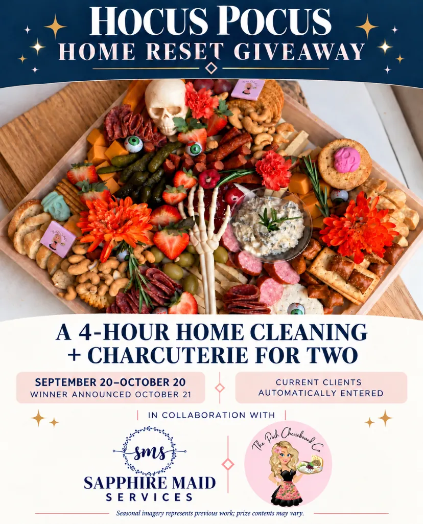 Promotional graphic for a Hocus Pocus Home Reset Giveaway featuring a Halloween-themed charcuterie board with meats, cheeses, crackers, pretzels, pickles, strawberries, eyeball decorations, flowers, and a skeleton hand. Text states a prize of 4-hour home cleaning plus charcuterie for two, with a contest running from September 20 to October 20 and winner announced October 21. Current clients automatically entered. Collaboration between Sapphire Maid Services and The Posh Cheeseboard Co.