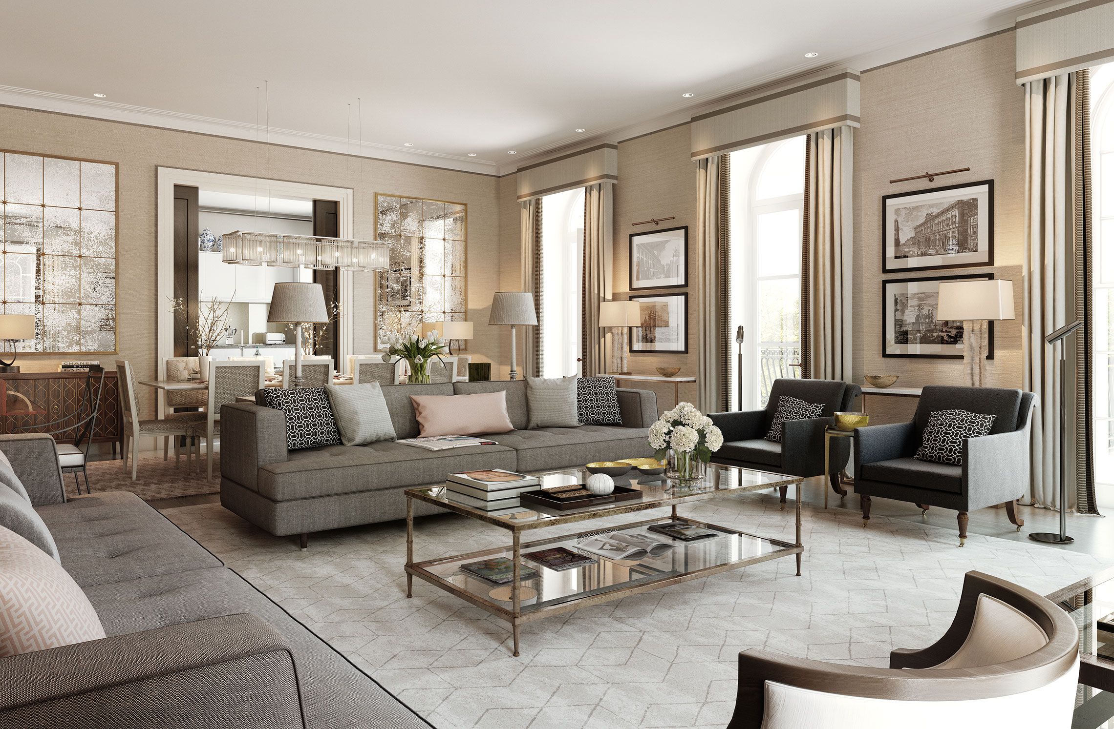 Elegant living room with beige walls, large gray sectional sofa, two gray armchairs, glass coffee table with books and flowers, and dining area in the background.